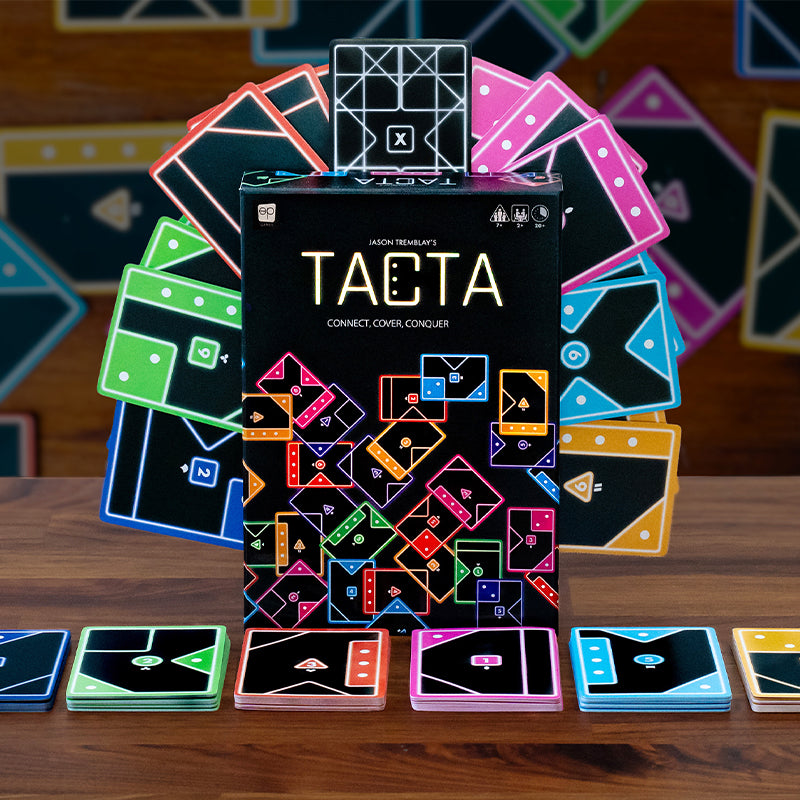 TACTA game box with colorful geometric tiles on a wooden surface