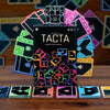 TACTA game box with colorful geometric tiles on a wooden surface